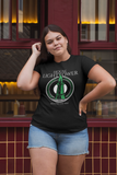 Woman wearing a black t-shirt with a graphic design in front of a bar.