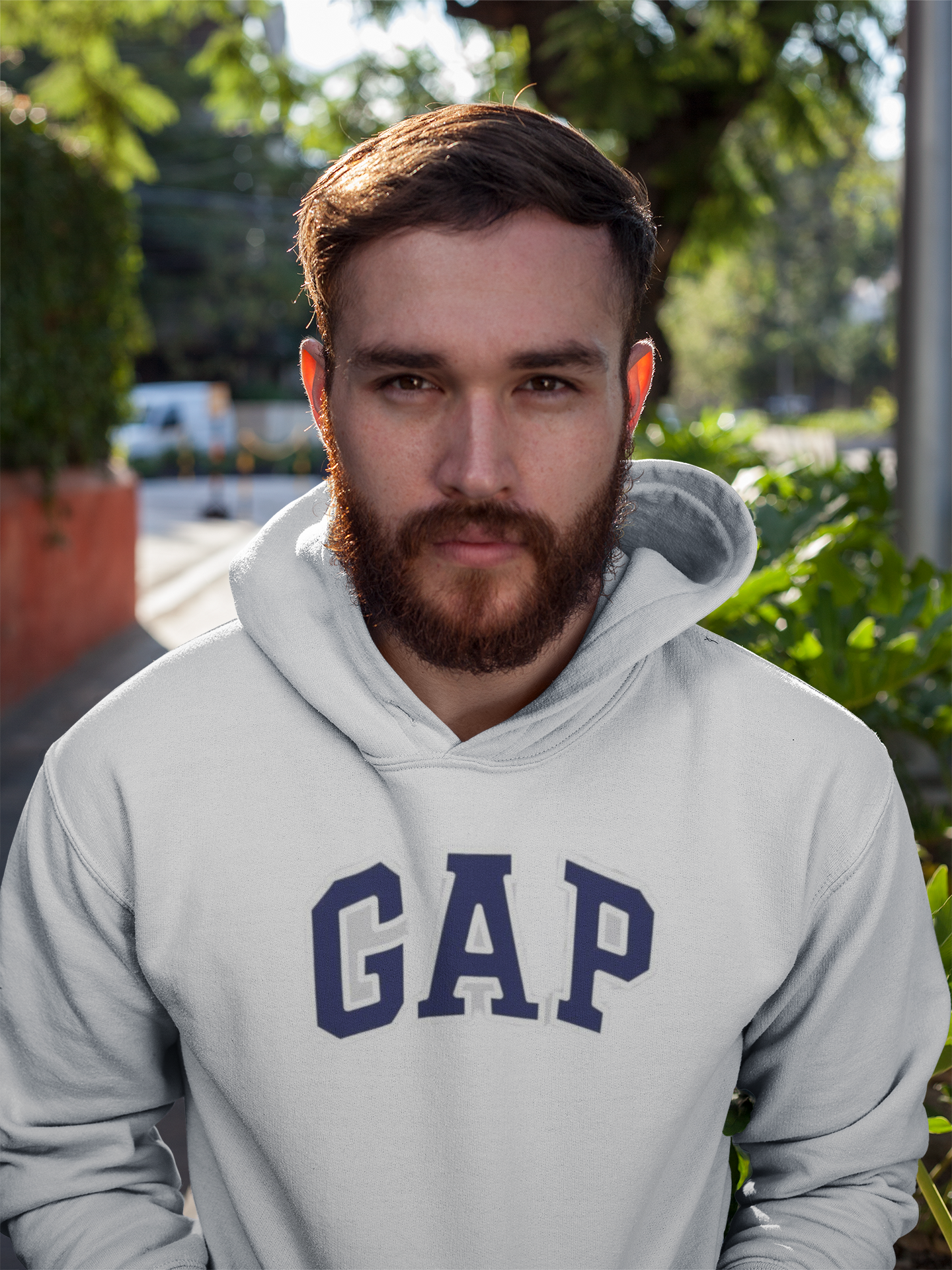 Man wearing a gray hoodie with 'GAP' logo outdoors